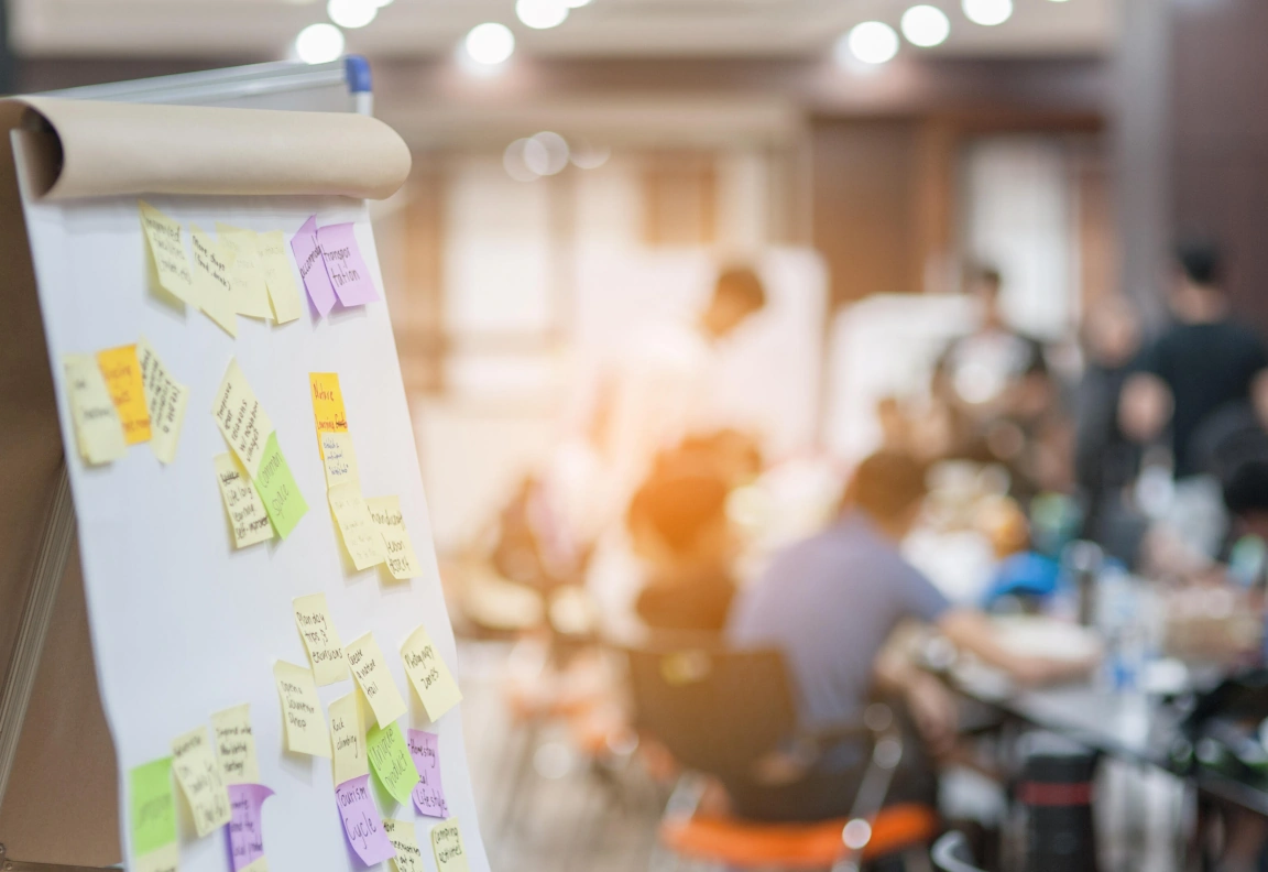 A flip chart with colorful post-its during a brainstorming session.